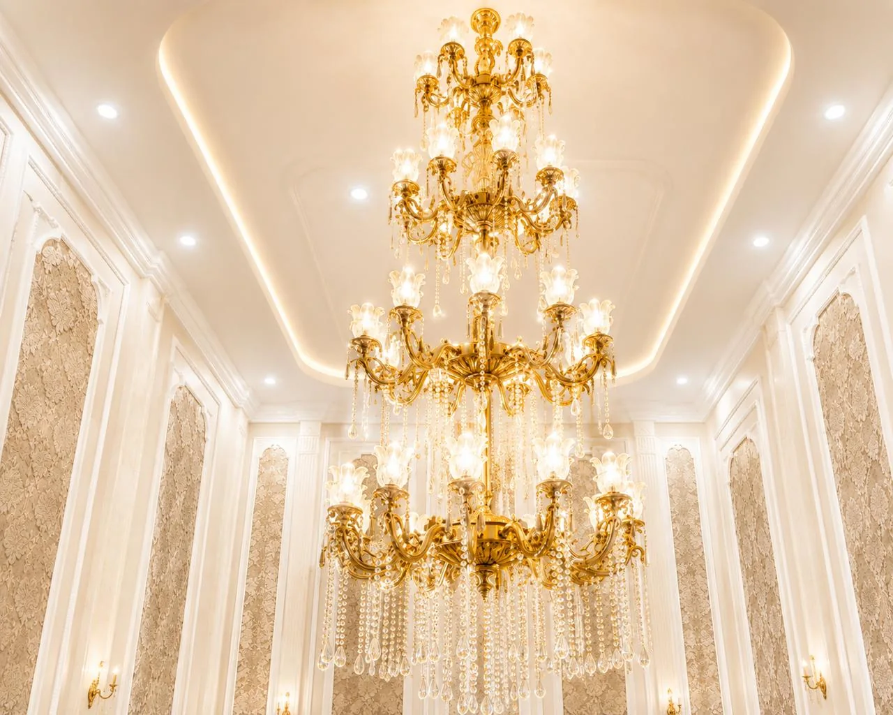 Large gold chandelier inside Royalston Grand